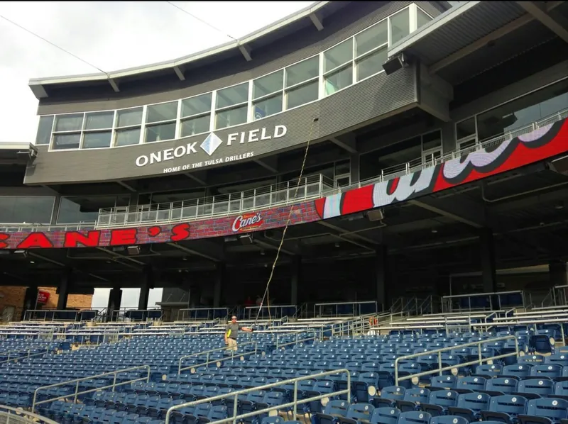 A water-fed pole reaching the upper glass at ONEOK Field from the seats below.